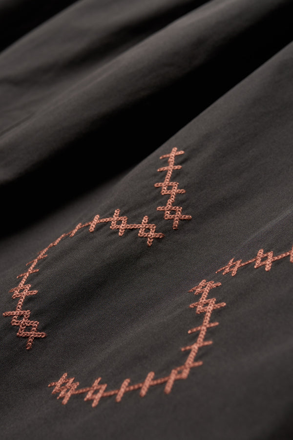 Close up embroidery details of the Black Universe Embroidered Skirt showcasing Arecibo-inspired motifs.