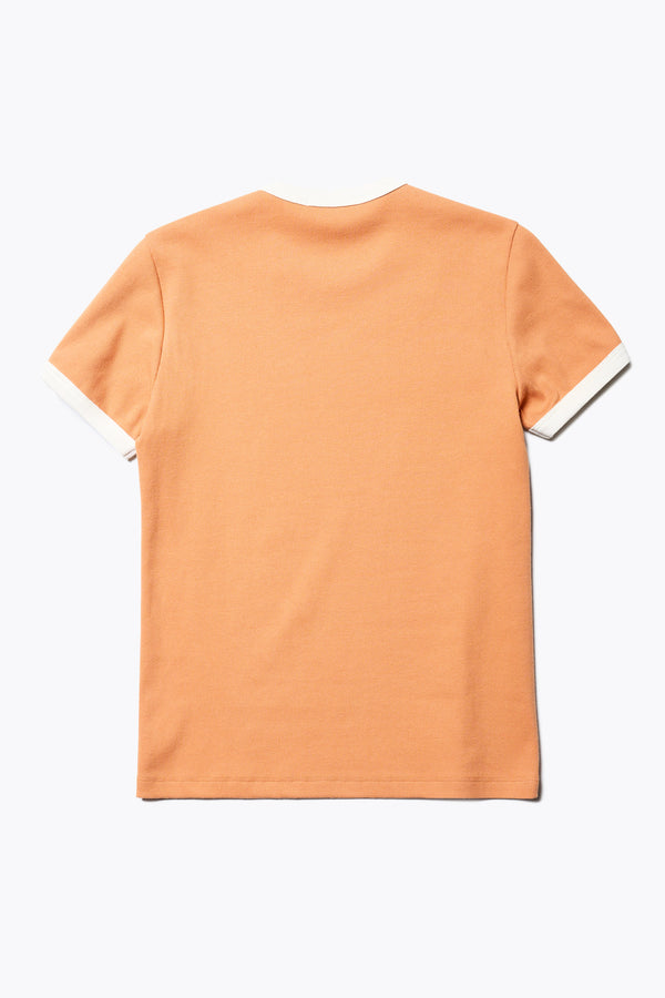 Flat back of the Veil Rib Tee a slim-fit ringer tee in pastel orange and ecru ribbed cotton, featuring a vintage 70's-inspired design with contrasting neckline and sleeve details. Available in 5 sizes. 