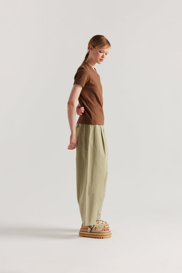 Side of Model wearing slim-fit 70s-inspired ringer tee in cocoa brown, made from Japanese ribbed cotton.