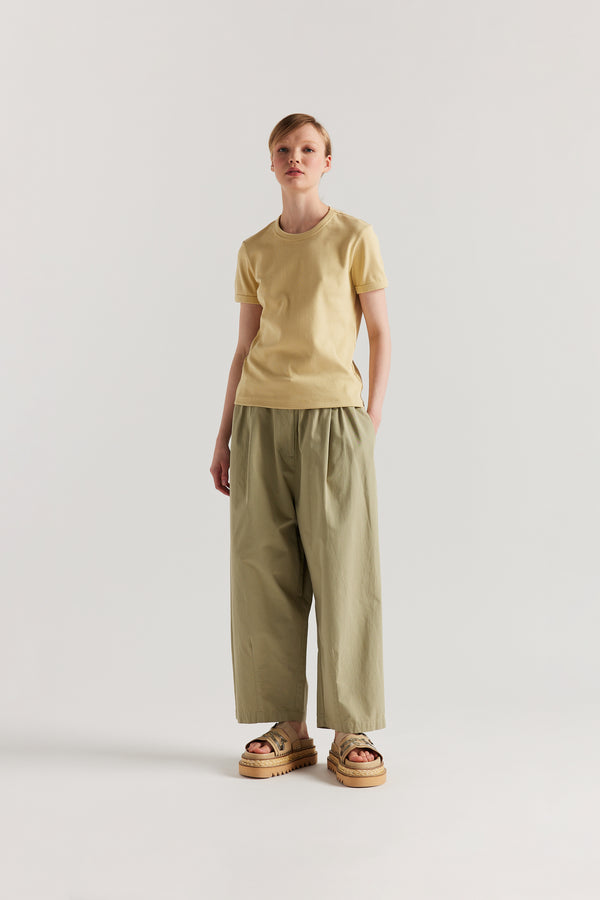 Front of Model wearing slim-fit 70s-inspired ringer tee in Pale Yellow, made from Japanese ribbed cotton.