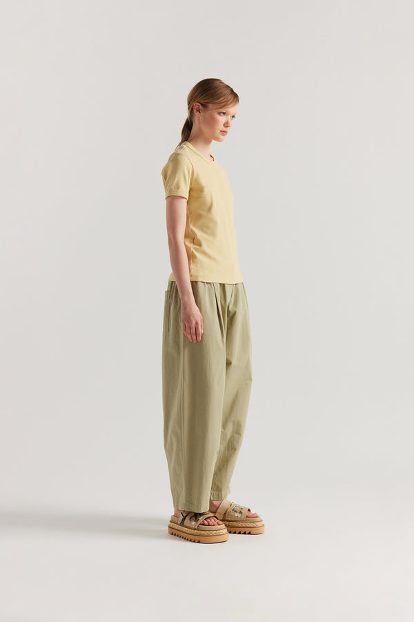 Side of Model wearing slim-fit 70s-inspired ringer tee in Pale Yellow, made from Japanese ribbed cotton.