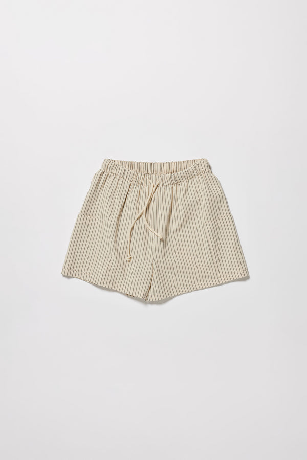 Flat front shot of the white and black pin stripe vesper short, a wide loose fit short with elasticated waistband. 