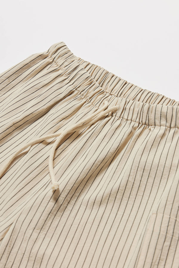 Close up fabric and detail shot of the white and black pin stripe vesper short in 100% Cotton. A wide loose fit short with elasticated waistband. 
