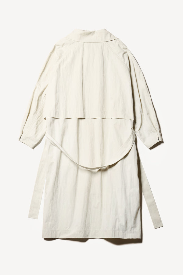 Flat Back of the Volt Trench in Bone. A lightweight double-breasted trench coat with flap pockets