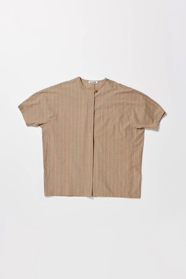 Flat front of the oversized boxy yarn-dyed cotton top with round crew neck and concealed placket in burnt orange, ecru and black stripe. 