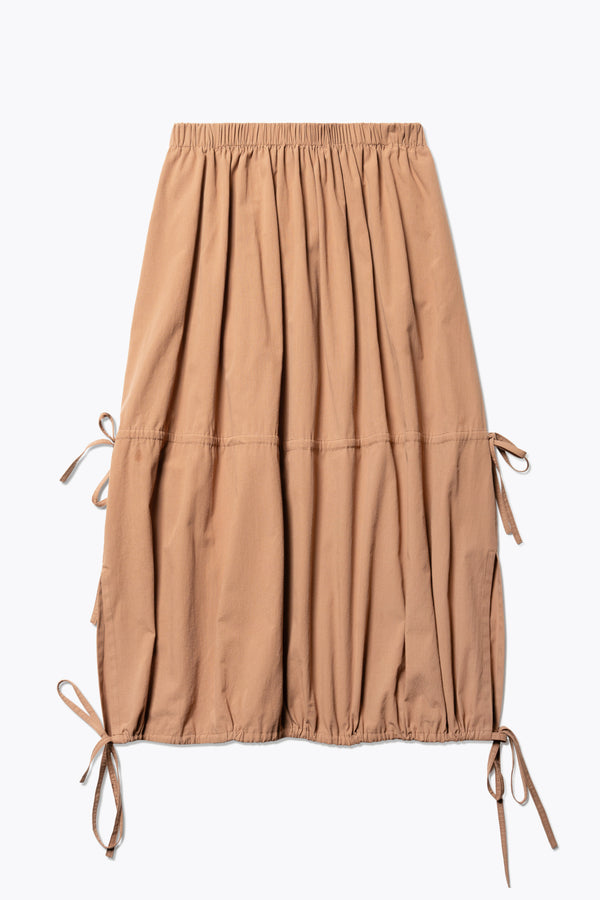 Flat Front of The Repose Skirt in toffee brown with an elasticated waist, tuck and channel pull-through details, and an adjustable hem for a customisable silhouette.