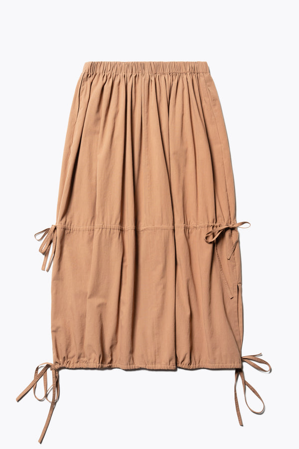 Flat back of The Repose Skirt in toffee brown with an elasticated waist, tuck and channel pull-through details, and an adjustable hem for a customisable silhouette.