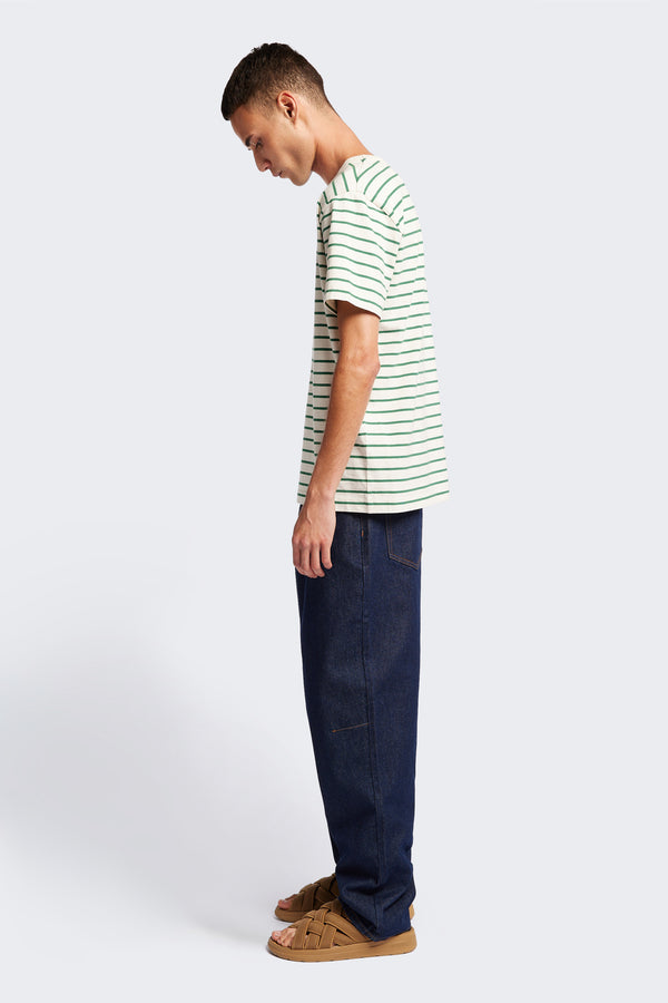 Side profile of the comfortable Radius T-Shirt Green Stripe, a traditional tee with a relaxed fit. Crafted from soft and durable high-grade organic cotton.