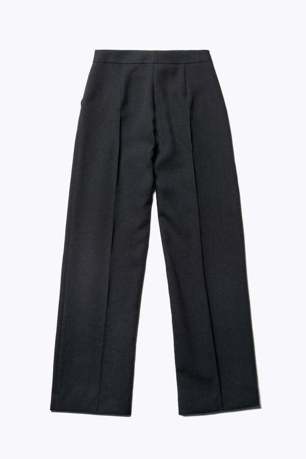 Flat Front view of the Tranquillity Pant in black, a slim-fit stovepipe-style tailored pant with pin tuck detailing.