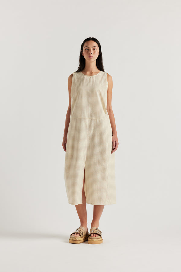 Front angle of female model in the cream Aureole Dress in textured seersucker with a relaxed, sleeveless silhouette