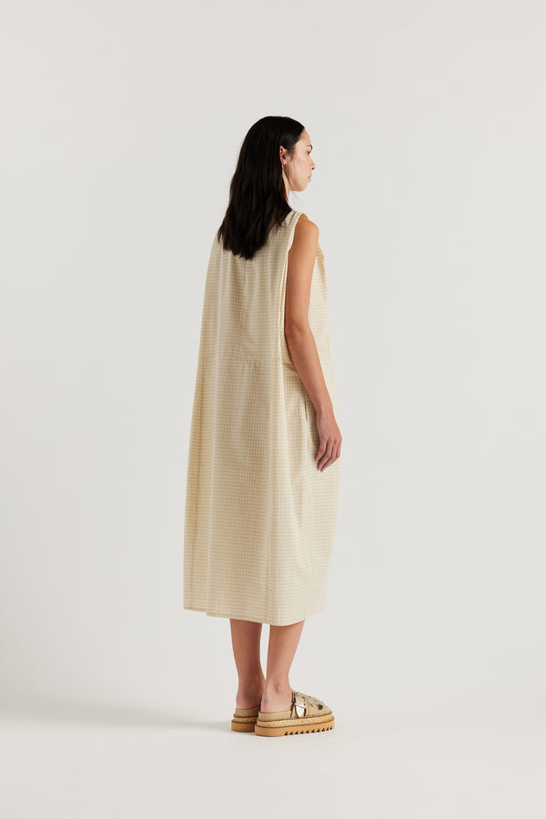 Back view of the cream Aureole Dress featuring a keyhole opening and loop-and-button closure.
