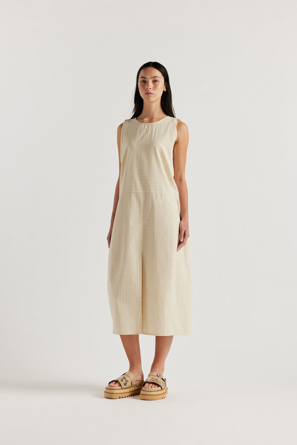 Front angle of female model in the cream Aureole Dress in textured seersucker with a relaxed, sleeveless silhouette