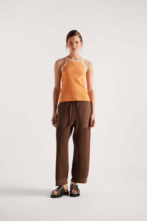 Model wears KLOKE knit pant in brown, front view