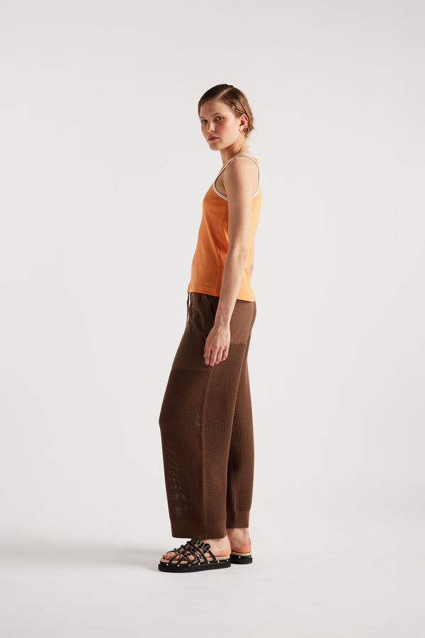 Model wears KLOKE knit pant in brown, side view
