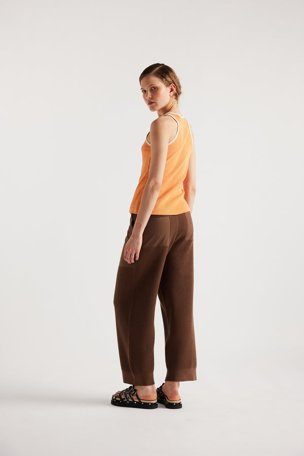 Model wears KLOKE knit pant in brown, back view