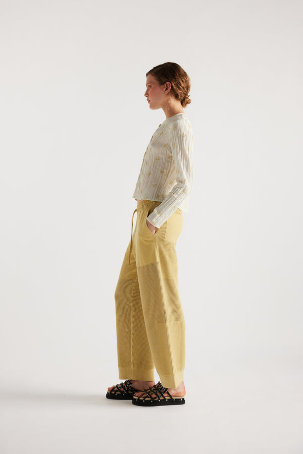 Model wears KLOKE knit pant in buttermilk, side view