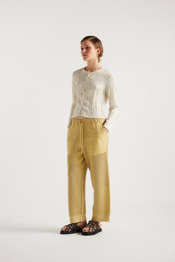 Model wears KLOKE knit pant in buttermilk, three quarter view