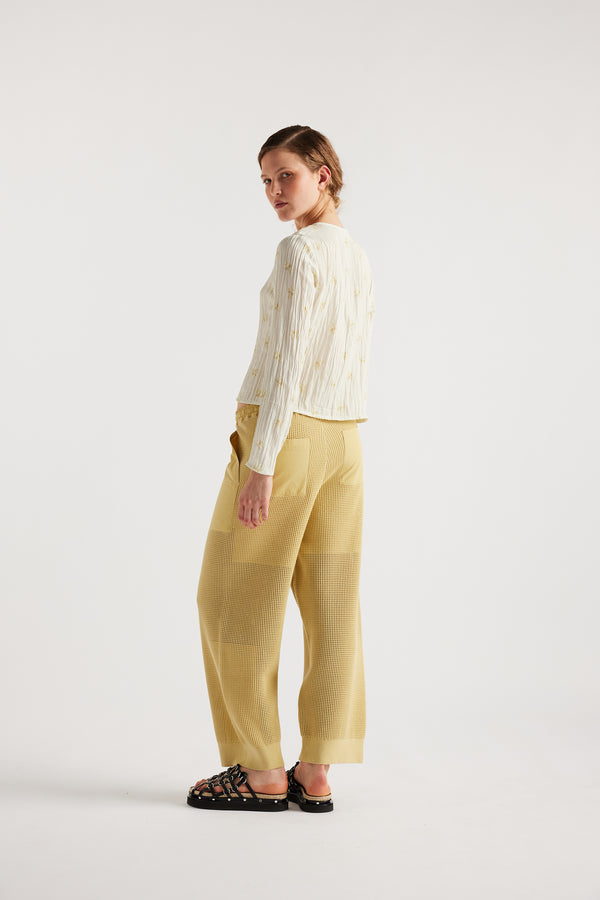 Model wears KLOKE knit pant in buttermilk, back view