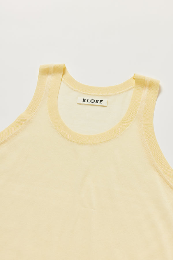 Close-up of KLOKE Direct Sheer Tank in pale yellow, scoop neckline and rib binding