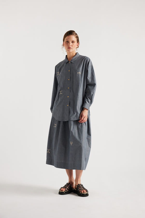 Model wearing KLOKE embroidered shirt in blue grey, front view
