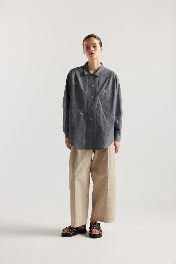 Model wearing KLOKE embroidered shirt in blue grey, front view