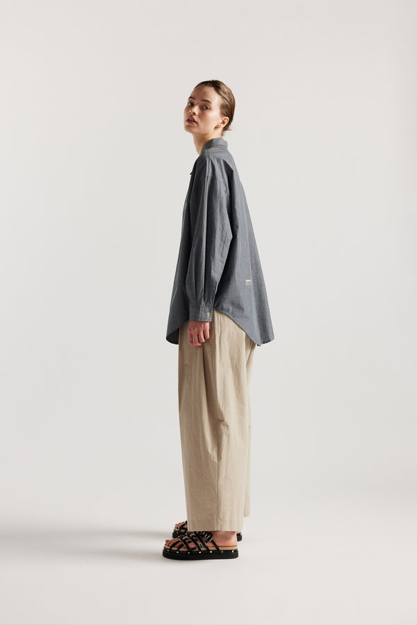 Model wearing KLOKE embroidered shirt in blue grey, side view