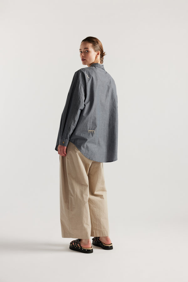 Model wearing KLOKE embroidered shirt in blue grey, back view
