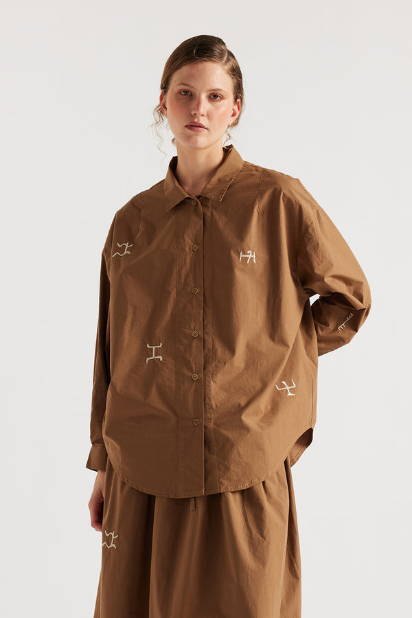 Model wearing KLOKE embroidered shirt in walnut brown, angled front view