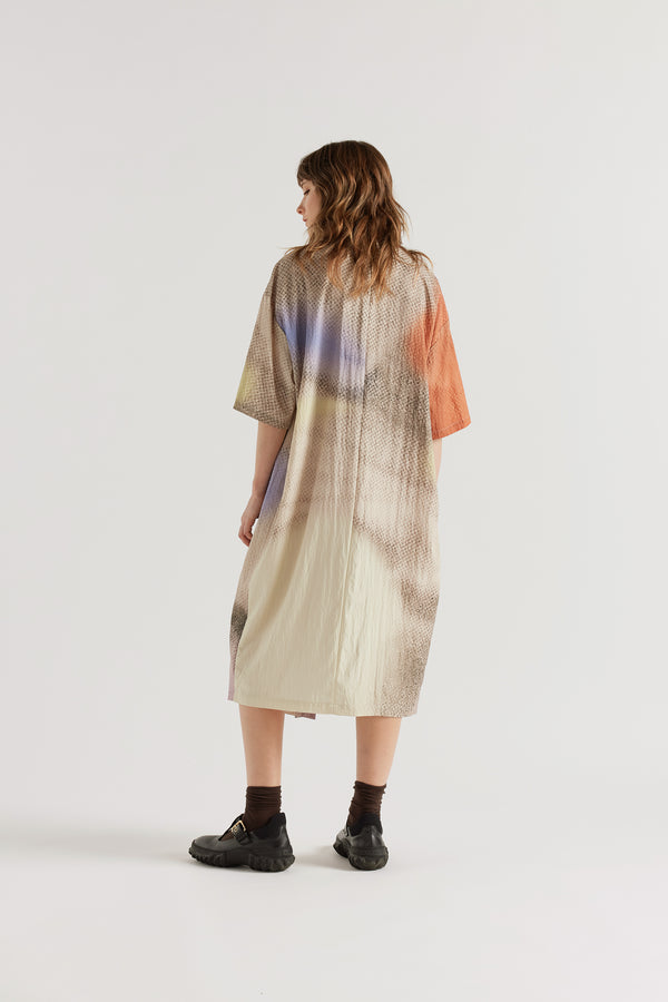 Back view of the Eon Dress in Aion Print showing fluid midi length and fragmented asymmetric deity print in mauve, blue and orange