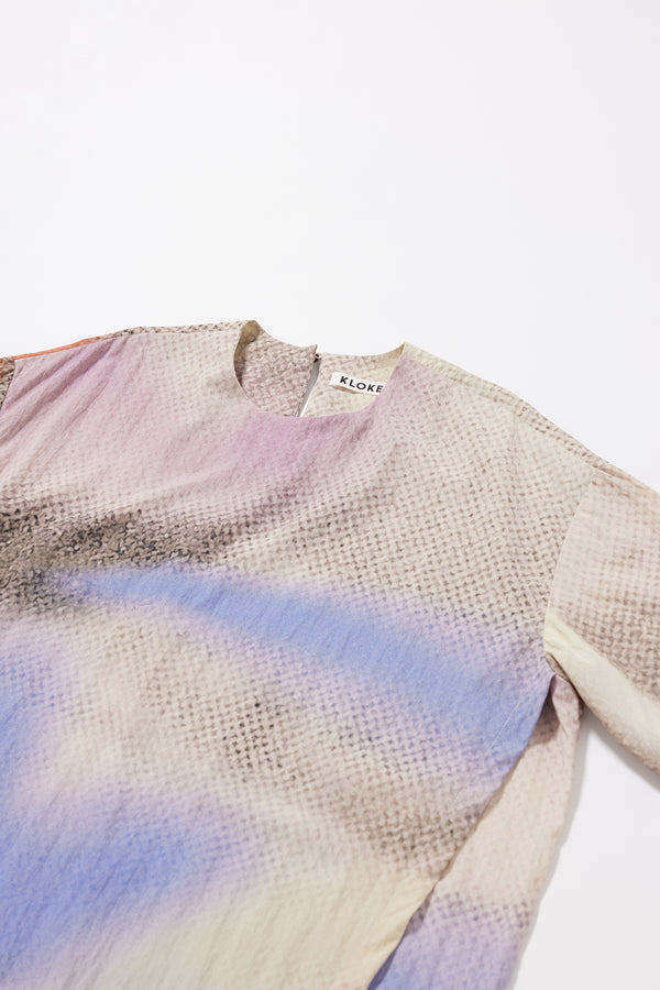 Close-up of the Aion Print on the Eon Dress showing fragmented asymmetric depiction of the deity of time in distorted mauve, blue and orange