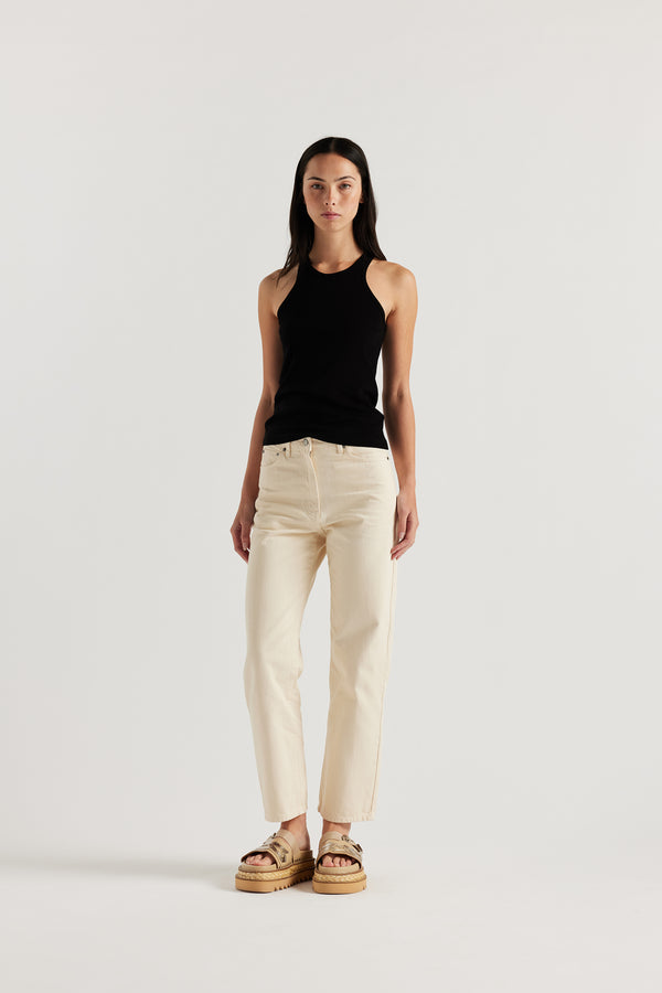 Front of the female model in the ecru Evade Jean in Japanese denim, featuring a straight-leg fit and slightly higher rise.