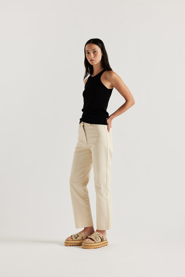 Front angle of the female model in the ecru Evade Jean in Japanese denim, featuring a straight-leg fit and slightly higher rise.
