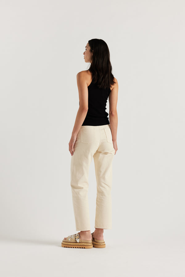 Back view of the female model in the ecru Evade Jean in Japanese denim, featuring a straight-leg fit and slightly higher rise.