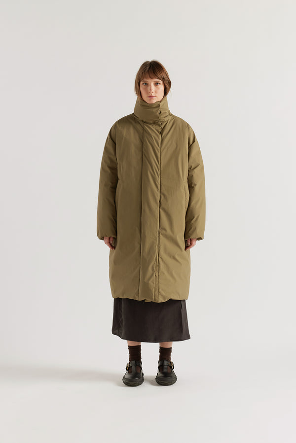 Front of  model in Olive Floating Puffa Coat worn closed, showing full-length silhouette, down-filled high collar and centre-front zip with magnetic fastenings