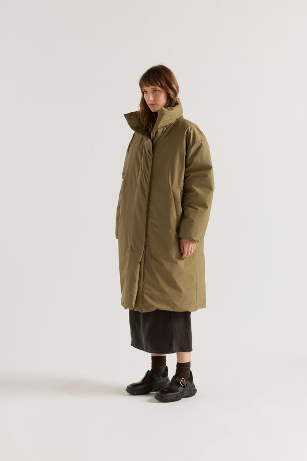 Front of  model in Olive Floating Puffa Coat worn closed, showing full-length silhouette, down-filled high collar and centre-front zip with magnetic fastenings