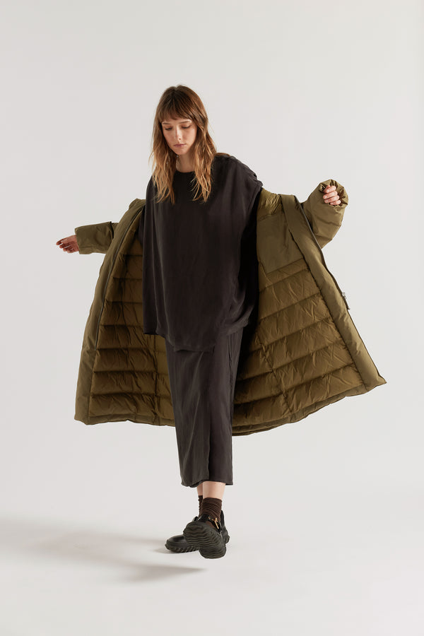 Front of  model in Olive Floating Puffa Coat worn open, showing full-length silhouette and quilted inner