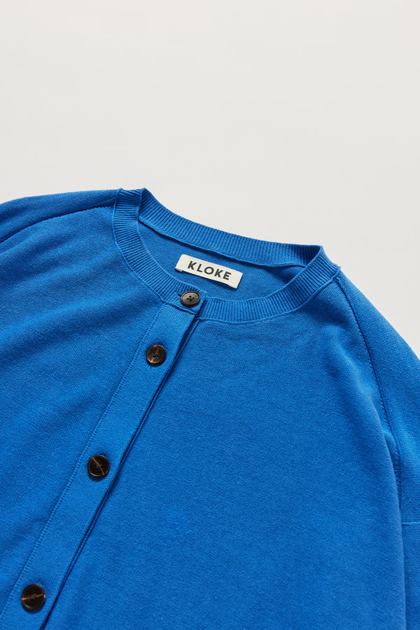 Close-up of KLOKE cotton cardigan crew neckline and button front