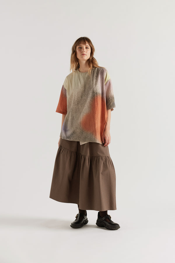 Glimmer Top in Aion Print front view showing round neck, short sleeves, asymmetric split front and fragmented mauve, blue and orange deity print