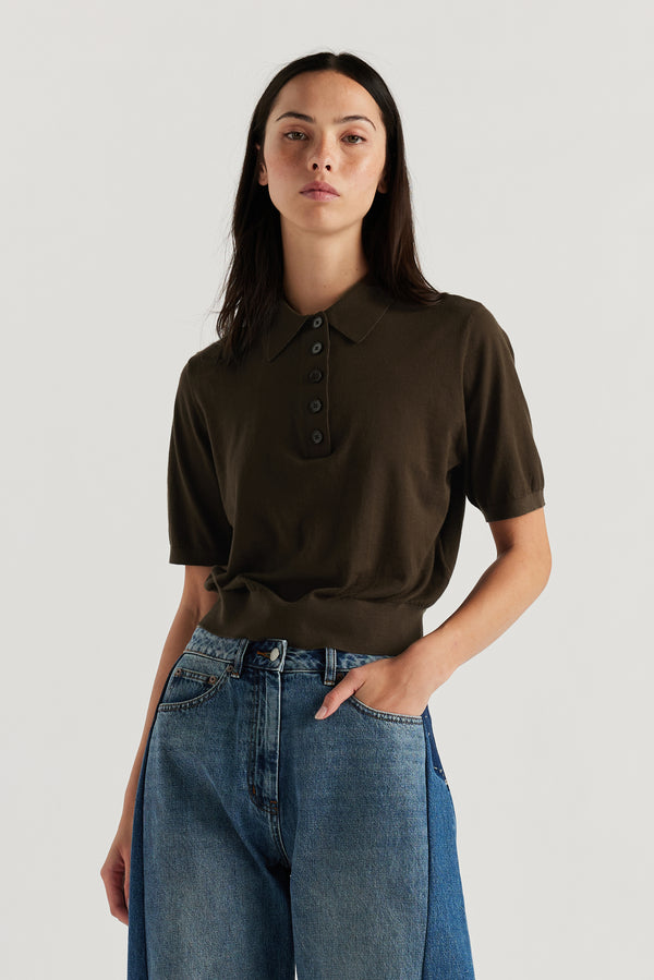 Female model wears KLOKE short sleeve impel polo knit in coffee with two tone jean, front close up view