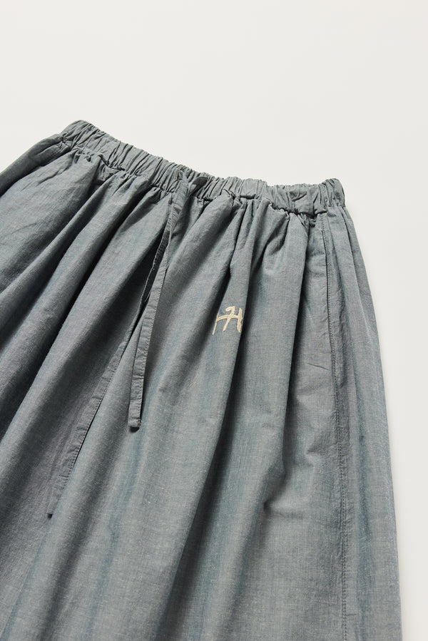 Detail of KLOKE embroidered skirt waistline and tie in blue grey