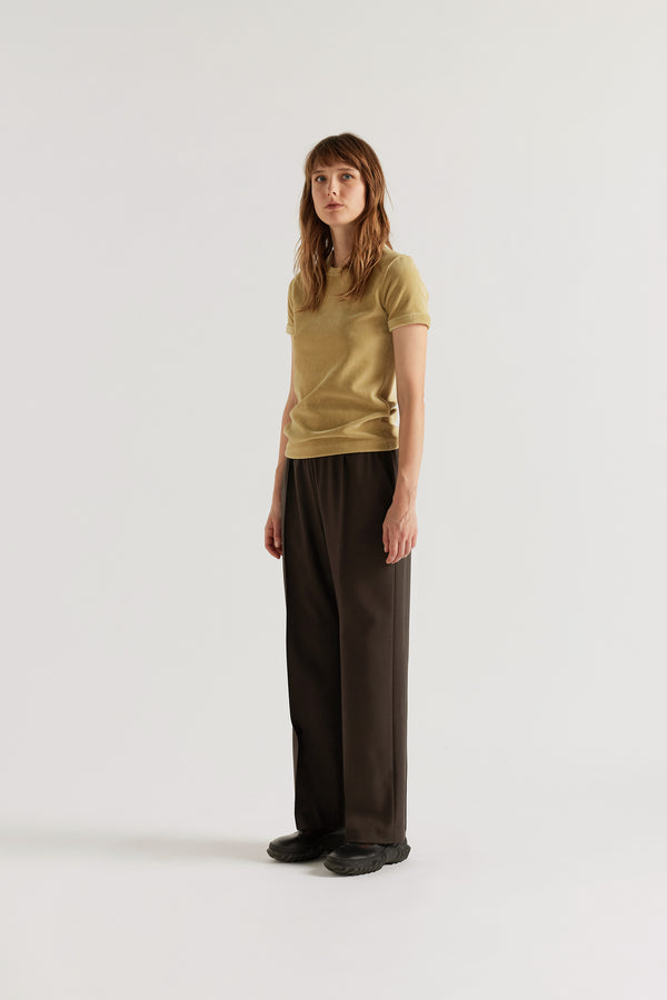 Front of model in the Dark Taupe Manta Pant with a tailored silhouette, elasticated waistband and front pin tuck detailing.