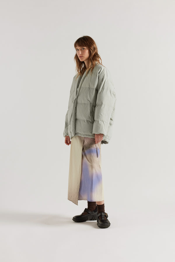 Front of model in Vintage grey Nimbus Kimono Jacket worn closed with centre-front self-tie, showing quilted recycled down construction and wrap silhouette