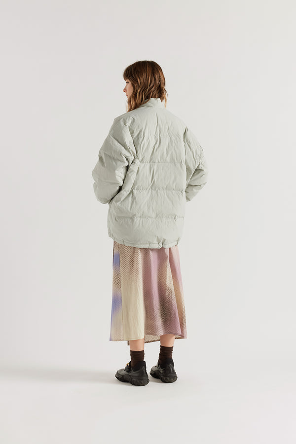 Back of model in Vintage grey Nimbus Kimono Jacket worn closed with centre-front self-tie, showing quilted recycled down construction and wrap silhouette