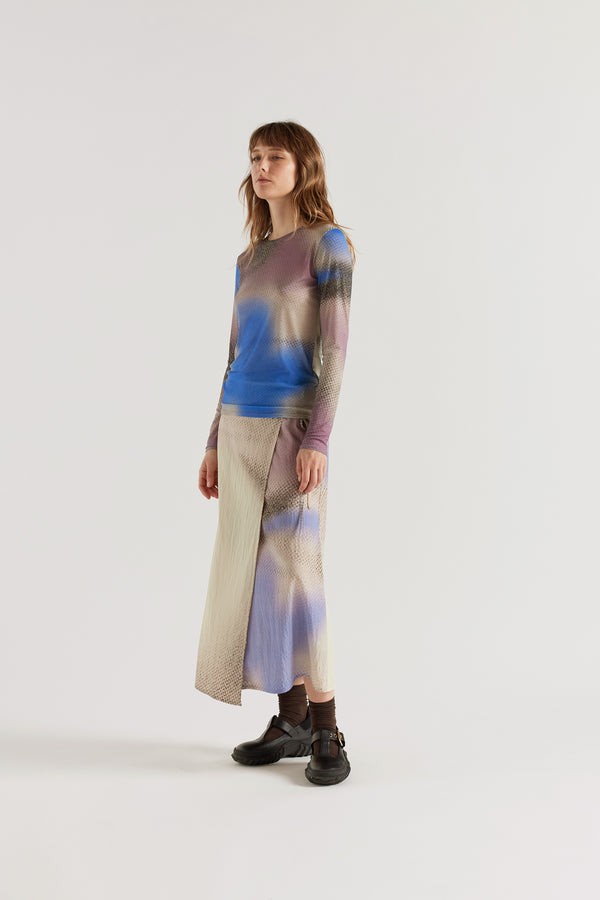 Purview Skirt in Aion Print front view showing wrap A-line midi silhouette with fragmented asymmetric deity print in distorted mauve, blue and orange