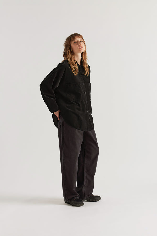 Front of model in the black Refraction cord shirt