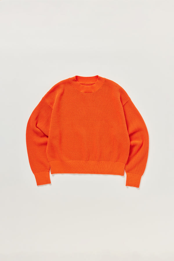 Flat lay of KLOKE pointelle-knitted cotton sweater in dutch orange, front view
