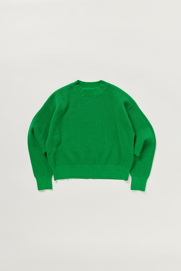 Flat lay of KLOKE pointelle-knitted cotton sweater in vivid green, front view