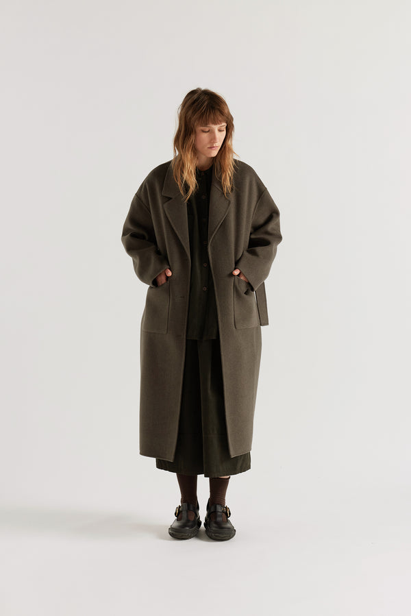 Retention Wool Coat in Olive Taupe worn open, showing hand-finished double-faced wool cashmere construction and full-length tailored silhouette
