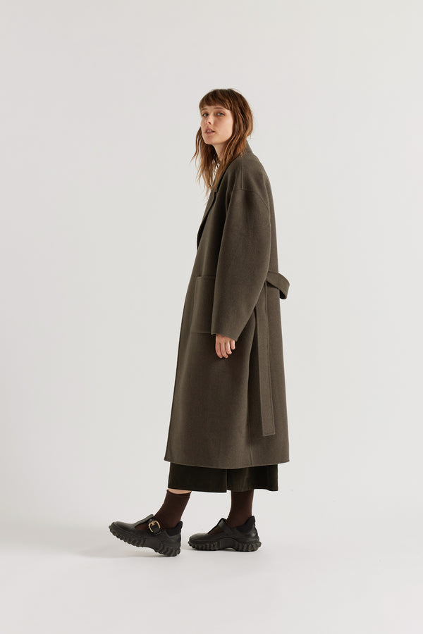 Side view of the Retention Wool Coat in Olive Taupe showing long tailored silhouette, dropped shoulder line and double-faced wool cashmere weight