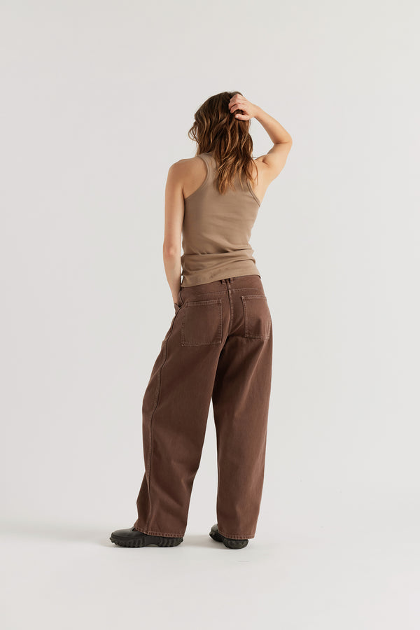 Back view of the  brown fade Unbound Jean featuring large patch pockets and a relaxed silhouette.